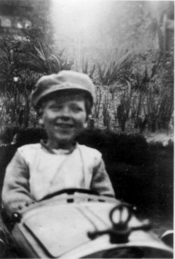 Sid aged 3 or 4 in his peddle car and his sister Eve, aged 5 or 6.